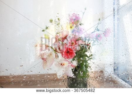 Beautiful Wallpeper Of A Flower Bouquet Standing Behind A Window Covered With Fresh Rain Drops