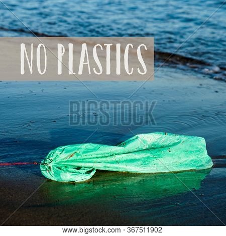 closeup of a used green plastic bag in a fish hook in the seashore, freshly fished in the ocean, and the text no plastics