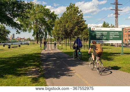Montreal, Ca - 7 June 2019: Cyclists Enjoying A Warm And Sunny Spring Day Along The Lachine Canal.