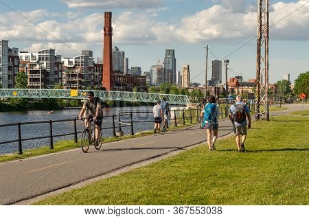 Montreal, Ca - 7 June 2019: Cyclists And Walkers Enjoying A Warm And Sunny Spring Day Along The Lach