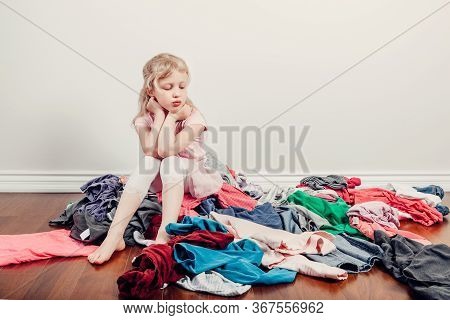 Mommy Little Helper. Bored Caucasian Girl Sorting Clothes. Tired Funny Child Arranging Organazing Cl