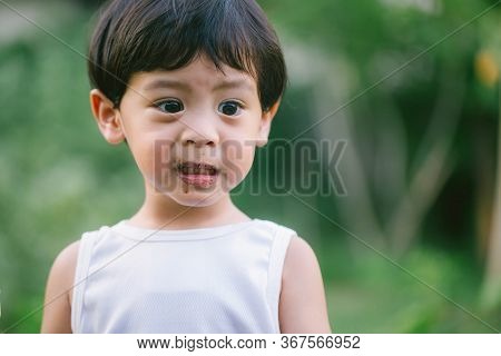 Asia Boy He Mouth Aftertaste From Eating Chocolate Ice Cream  Or Chocolate Dessert. A Sweet-toothed 
