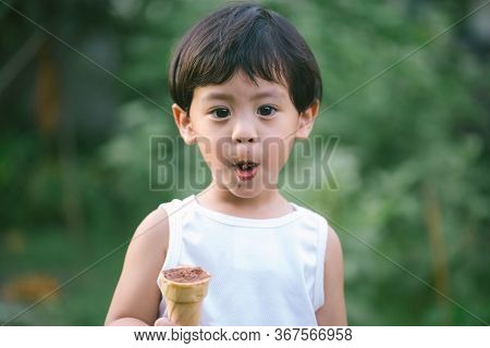 Asia Boy He Mouth Aftertaste From Eating Chocolate Ice Cream  Or Chocolate Dessert. A Sweet-toothed 