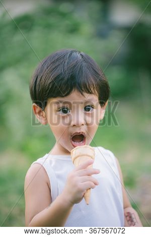 Asia Boy He Mouth Aftertaste From Eating Chocolate Ice Cream  Or Chocolate Dessert. A Sweet-toothed 