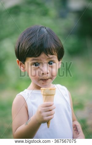 Asia Boy He Mouth Aftertaste From Eating Chocolate Ice Cream  Or Chocolate Dessert. A Sweet-toothed 