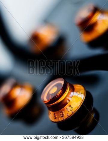 An Extreme Close Up On The Volume And Tone Dials Of A Semi Acoustic Guitar