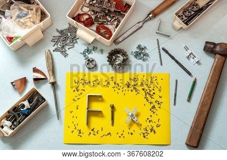 Top View Of Construction Tools And A Construction Fastener. Piece Of Paper With The Word Fix Laid Ou