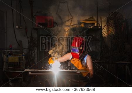 Female Welder Working In Heavy Industry Factory.