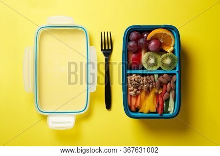 Top View of Full Lunch Box with Fuits, Vegetables and nuts.