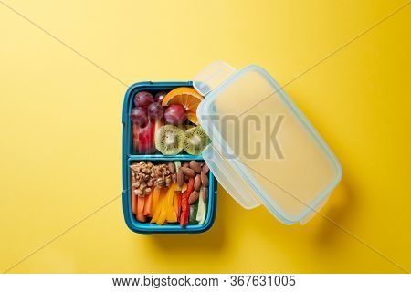 Top View of Full Lunch Box with Fuits, Vegetables and nuts.
