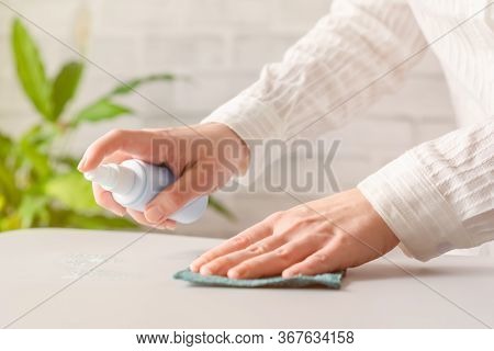 Hand Of Woman Cleaning Reception Desk. Disinfection Spray, Small Towel. Protection From Bacteria And