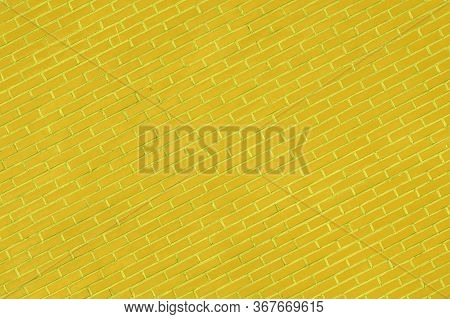 Photo Of A Sloping Yellow Brick Wall. Yellow Brick Wall For Background Or Texture. Old Yellow Brick 