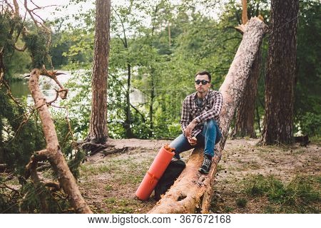 Portrait Young Male Hiker Eating Apple. Tourist At Forest, Stop For Rest And Eat Apple. Fit Man Eati