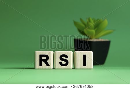 Rsi - Business Concept On A Green Background. Wooden Cubes And Flower In A Pot.