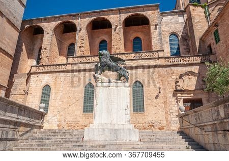 Sineu, Balearic Islands/spain; May/20/2020: Bronze Statue Of A Lion, On The Stone Staircase Leading 