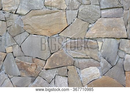 Abstract Gray Stone Background. Mosaic Pattern Of Old Brown Stones On The Facade Of The House. Rock 