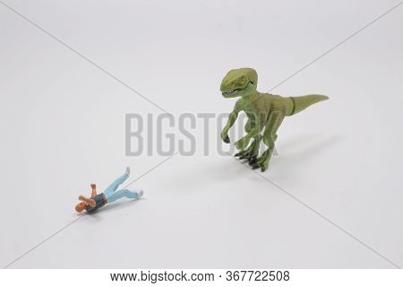 A Timy Figure Man Fight The Dinosaur Toy
