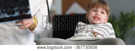 Portrait Of Cheerful Little Patient Having Fun With Pediatrician In Hospital. Happy Smiling Child In
