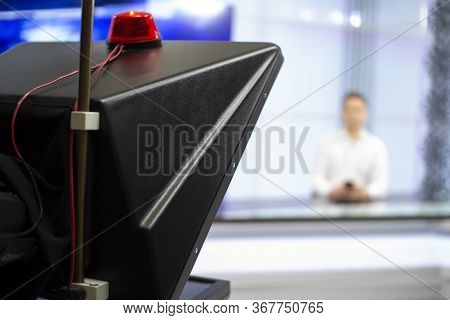 A Male News Anchor In A Broadcast Studio Reads Text On A Teleprompter. Camera In The Tv Studio.