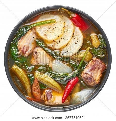 Sinigang Na Baboy Or Filipino Pork Meat Soup In Black Bowl Isolated On White Backdrop. Sinigang Is A