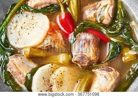 Sinigang Na Baboy Or Filipino Pork Meat Soup Close Up. Sinigang Is A Filipino Cuisine Dish With Meat