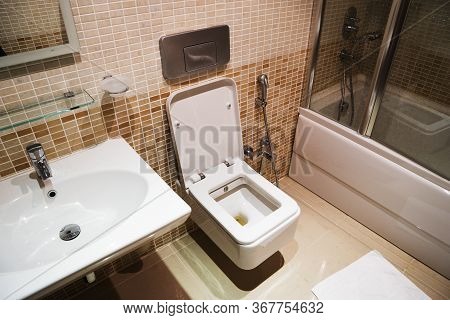 White Modern Ceramic Sinks And Toilet In The Bathroom.