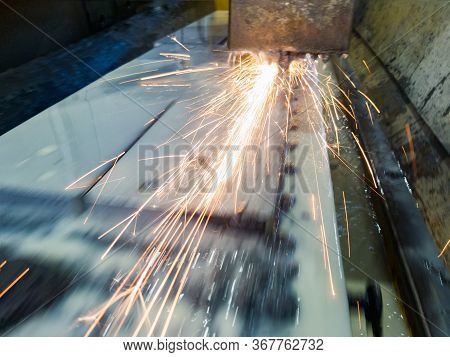 Grinding The Plate On A Surface Grinding Machine. Sparks And Water Cooling On A Magnetic Table