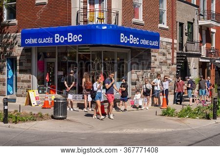 Montreal, Ca - 23 May 2020: People In Line To Buy Ice-cream During Coronavirus Pandemic On Laurier S
