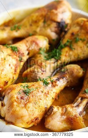 Fried Chiken Drumstick Served In White Bawl Wiht , Salad And Turmeric