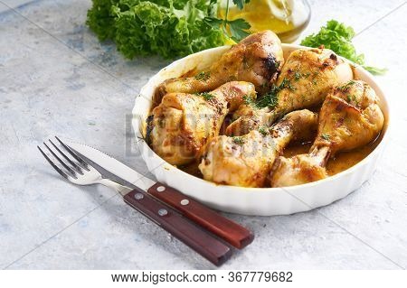 Fried Chiken Drumstick Served In White Bawl Wiht , Salad And Turmeric
