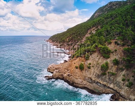 Green Vegetation On Mountains, Rocky Coastline And Wavy Mediterranean Sea Surf During Sunny Day Fluf