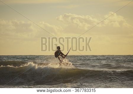 Bali, Indonesia-march 2020: Young People Ride On Short Boards On The Waves. Extreme Jump, Sports And