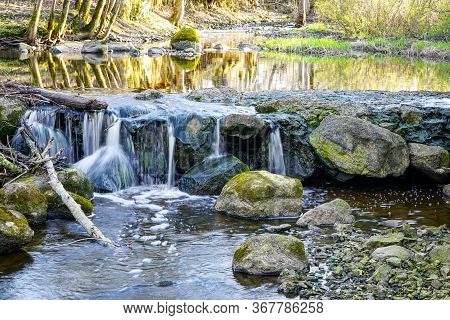 Beautiful View In Spring Of A Waterfall In A Small River