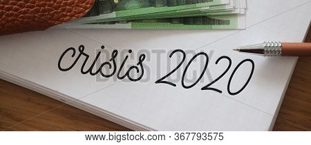 Crisis 2020 Written On Page Of Copybook And 100 Euro Bills. Little Money Left, Business Bancruptcy C