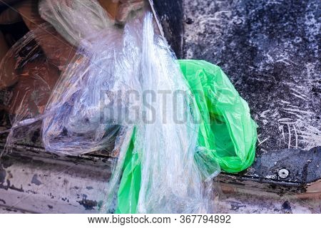 White And Green Plastic Rubbish In Old White Container For Plastic Waist. Garbage Sorting Concept. E