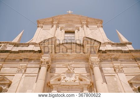 Facade Of The Church Of Saint Ignatius In Dubrovnik, Croatia. Statue Of An Angel Above The Entrance 