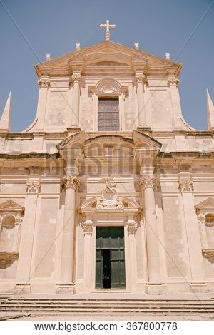 Facade Of The Church Of Saint Ignatius In Dubrovnik, Croatia. Statue Of An Angel Above The Entrance 