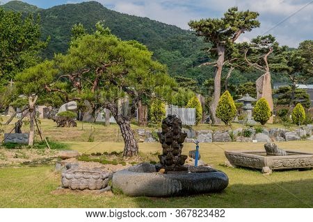 Gimcheon, South Korea; May 24, 2020: Water Fountain Inside Large Hollowed Boulder In Public Rock Gar
