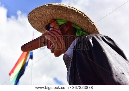 Cusco, Cusco, Peru - June 10, 2017: Peruvian Man Wearing A Large Nose Mask During A Religious Celebr
