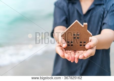 Copyspace Model Of A Little House That Woman Holds It Background.