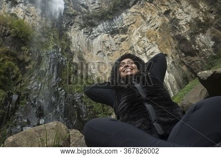Urubici, Santa Catarina, Brazil: Afro Brazilian Woman Smiles Amid The Forest, Wearing Winter Clothes