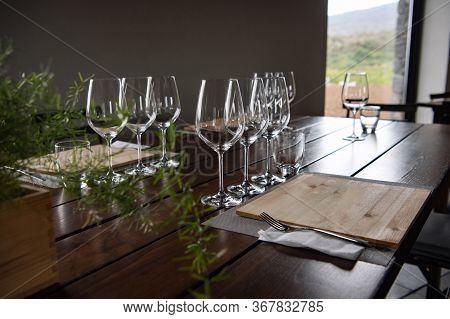 Beautiful Table Setting In A Restaurant With Empthy Wine Glasses. European Gourmet Restaurant. Cozy 