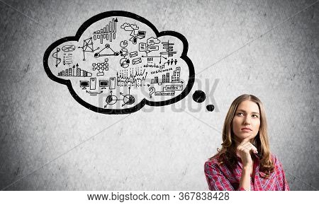 Serious Woman Looks Pensive Upwards And Thinking Something. Speech Bubble Full Of Business Diagrams 