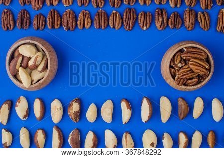 Pekan And Brazil Nuts On Blue Background. Healthy Food