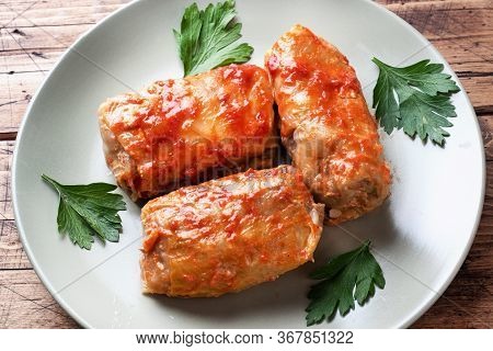 Cabbage Rolls With Beef, Rice And Vegetables On The Plate. Stuffed Cabbage Leaves With Meat. Wooden 
