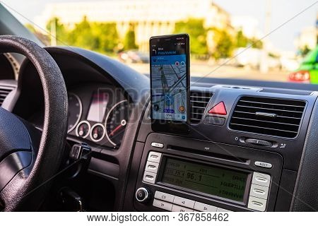 In Car Dashboard View With Smartphone Showing Police On Waze Maps. Driver Using Waze Maps In Buchare