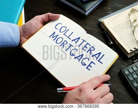 Man Writes Collateral Mortgage Sign On The Sheet.