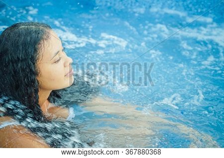 Happy Young  Enjoying A Bath In The Jacuzzi. Brunette Woman Relaxing In Jacuzzi. Relax, Spa And Holi