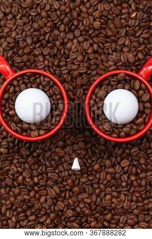 Two Red Cups Full Of Coffee Beans And One Golf Ball.  Fair Trade. Commodity Trade. Fresh Coffee Bean