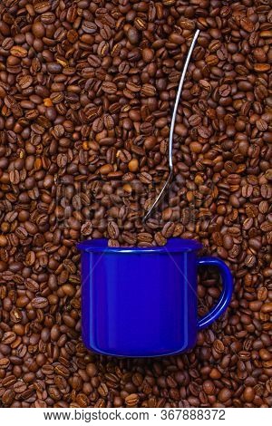 Blue Cup Of Coffee On A Table Full Of Coffee Beans.  Coffee Design.